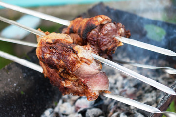 Two pieces of meat roasted on a grill.