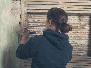 Young woman removing plaster