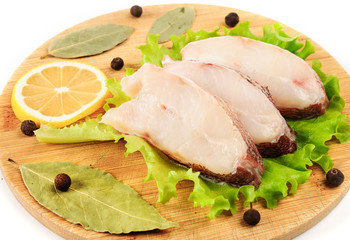 Pieces of sea bass on a cutting board.