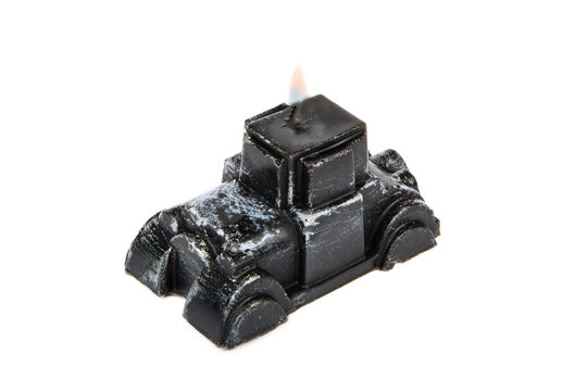 Souvenir gift candle in the shape of black retro car isolated on