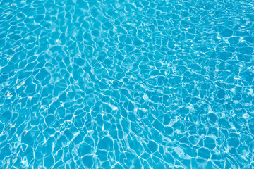 Ripple water surface and sun reflection in swimming pool