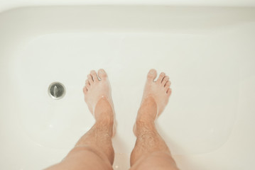 Photo of man's feet in the shower
