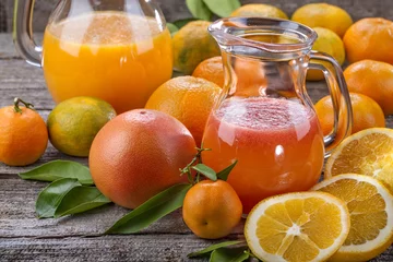 Papier Peint photo Lavable Jus refreshing juice of mandarin, orange and red grapefruit with pulp