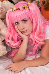 young girl in a bedroom with a pink wig