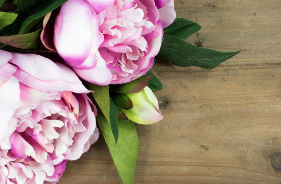 Fototapeta Pink Peonies on rustic old wooden background.  Celebration concept.