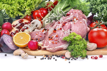 .fresh pork neck with various vegetables on a white background