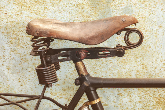 Detail of a rusted ancient bicycle with leather seat