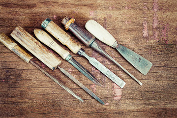 Old vintage rusty carpenter tools on grunge wooden background in vintage style