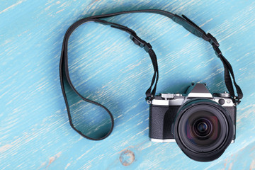 Digital camera with retro style on turquoise background