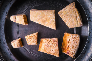 Pieces of pastila on the metal plate top view