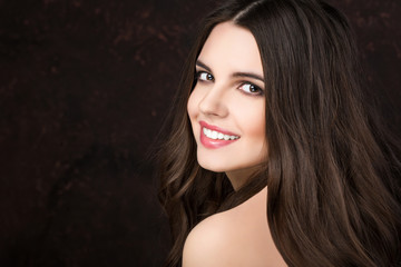 Beauty Woman with Long Brown Wavy Hair.