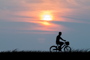 Fototapeta na wymiar silhouette of the cyclist on road bike at sunset