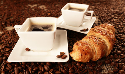 Cups with coffee and coffee beans