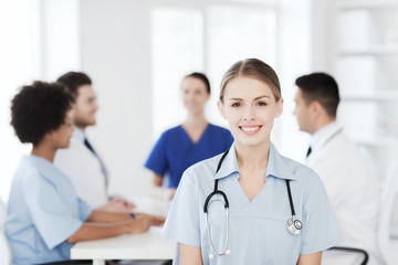 happy doctor over group of medics at hospital