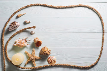 Wooden background with starfish, sea shells and marine rope