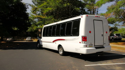 Limo bus drives off.