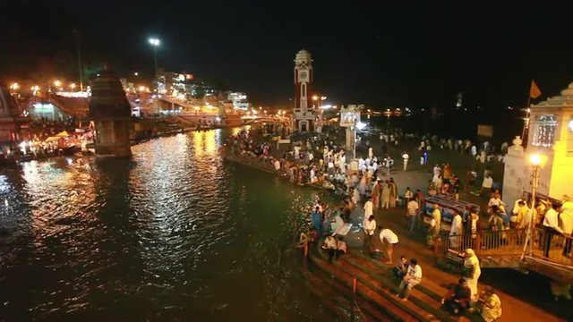 Pan shot of pilgrims at the ghats of Ganges River, Haridwar, Uttarakhand, India