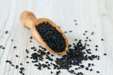 black cumin on wooden surface
