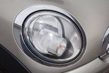 Close up of a grey car headlight