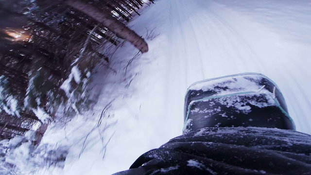 fast Snowmobile POV Back View in a Forest Path
