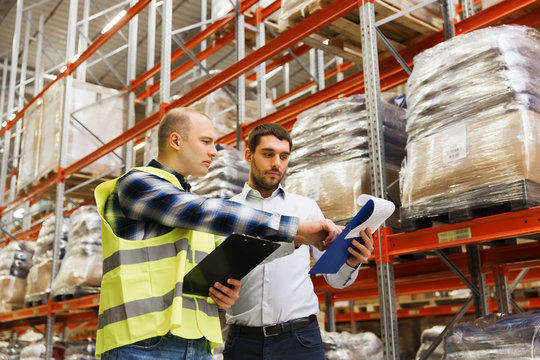 worker and businessmen with clipboard at warehouse
