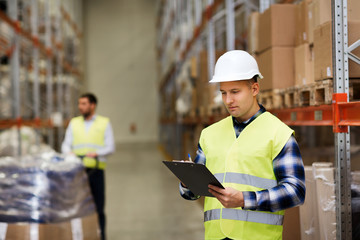 Fototapeta premium man with clipboard in safety vest at warehouse