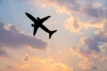 Silhouette Airplane in the sky at sunrise