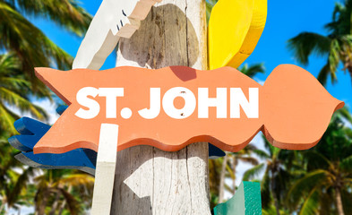 St John welcome sign with palm trees