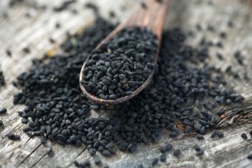 black cumin on wooden surface