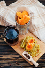 food, chicken nuggets and cola and fried potatoes on a wooden background