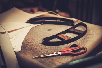 Shoemaker studio craft working desk with professional tools.