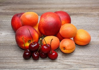 Nectarines, cherries and apricots on wooden table