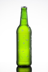 Bottle of ice cold beer with ice and drops