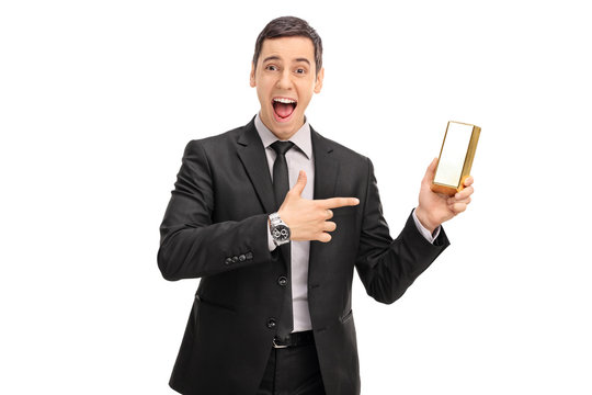 Ecstatic businessman holding a gold bar