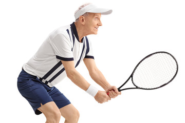 Active senior man playing tennis