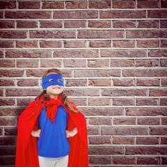 Composite image of masked girl pretending to be superhero