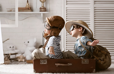 Boys in images traveler and pilot play in his room - 102935175