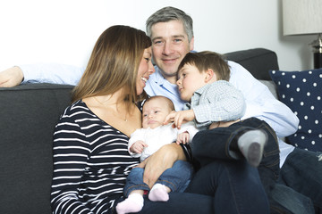 Obraz premium happy family mother, father and two children at home