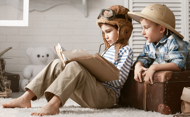 Boys in images traveler and pilot play in his room