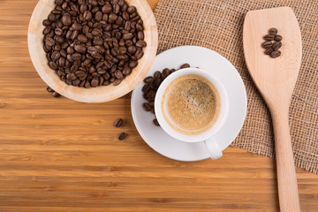 Obraz na płótnie Canvas Coffee beans in bowl on wooden background
