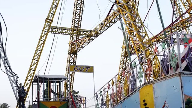 Locked-on shot of boat swing ride in an amusement park at Pushkar Fair, Pushkar, Rajasthan, India