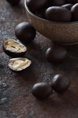 peanuts in chocolate on an old metal surface