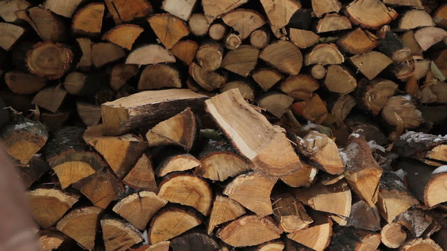  Man putting log on pile 