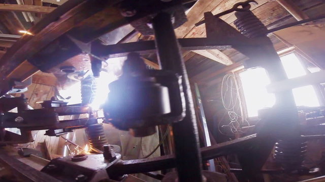Man Welding a Snowmobile Frame at Home in a Workshop