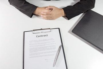 Businesswoman sitting with contract in front of her