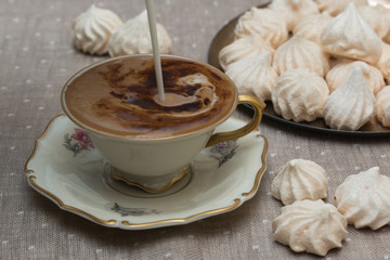 Coffee with milk in porcelain vintage cup.
