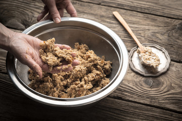 Kneading dough to cook biscuits in a metal plate