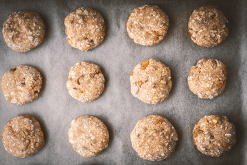 Oatmeal cookies on a baking sheet covered with parchment