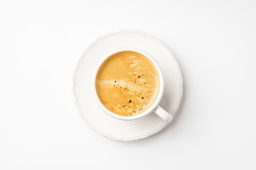 Coffee in ceramic cup on a white table