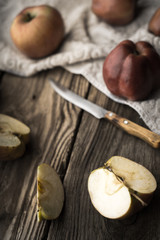 Red apples and apple halves on a wooden table